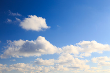 Bright cumulus clouds against the blue sky. Sunset sky Natural background. seascape