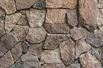Obraz premium Texture: a wall of folded natural stone, reinforced with a small amount of cement.