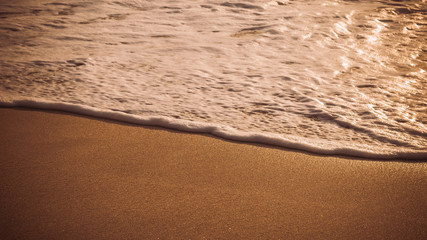 Gentle Wave Rolling over Sandbeach in Sunset light, Beautiful Crystal Bay, Nusa Penida Bali