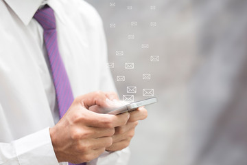 Businessman using smartphone with pushing email icon to communication 