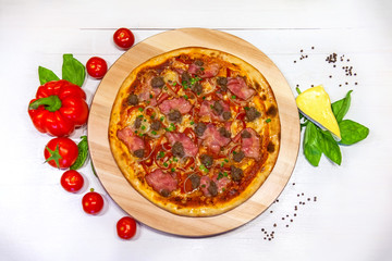 pizza with bacon, bell pepper and basil on a white background, flat lay
