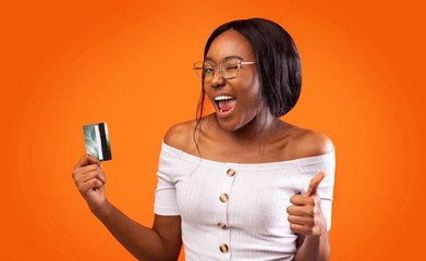 Afro Woman Showing Credit Card Gesturing Thumbs Up, Studio Shot