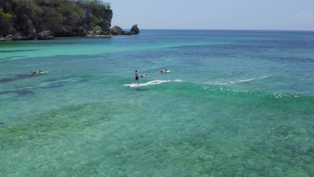 man who straddled the wave between other surfers, Bali, Indonesia, 4k