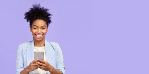 Happy afro girl using mobile phone at studio