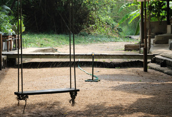 The swing and a stream with no water background.