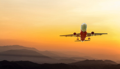 Naklejka na ściany i meble Travel concept with airplane ,mountain and sky at sunset 