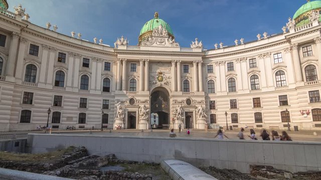 Hofburg palace timelapse hyperlapse in Vienna, Austria. People walking on Michaelerplatz. The Hofburg is the imperial palace of the Habsburg rulers in Vienna, consisting of over 2500 rooms.