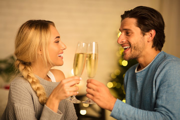 Cheers! Happy spouses clinking champagne glasses, side view