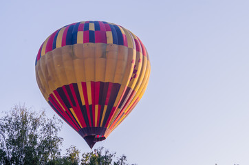 hot air balloon is flying at sunrise. romantic balloon flights