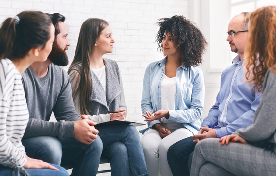 Glad patients talking with professional therapist, panorama