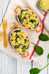 Spinach Mac and Cheese on Wooden Background. Selective focus.