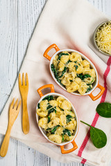 Spinach Mac and Cheese on Wooden Background. Selective focus.
