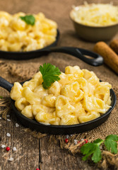 Macaroni and Cheese Old Fashioned Skillet on Wooden Background. Selective focus.
