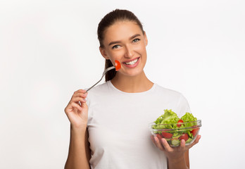 Happy Young Lady Enjoying Fresh Vegetable Salad Posing, Studio Shot