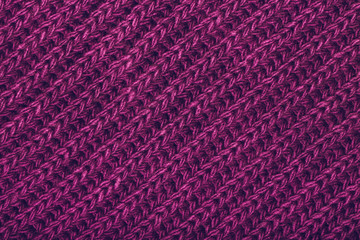 Knitted magenta scarf texture. The concept of cozy, comfort, warm, softness or winter