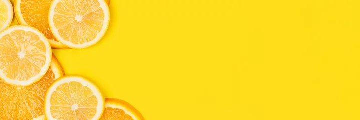 Foto op Plexiglas Juicy citrus on a yellow background. Bright vitamin photo. Copy space, web-banner format. © elena_fedorina