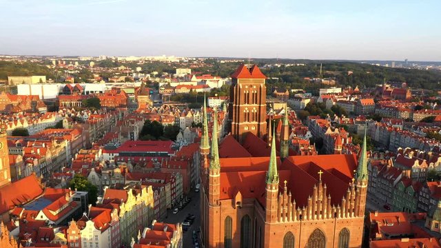 Gdansk, Poland. Aerial 4K reveal video of old city, Motlawa river and famous monuments: Gothic St Mary church, city hall tower,