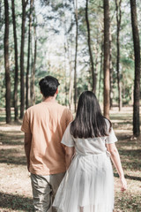 Fototapeta premium Pregnant woman and Husband posing outdoors.