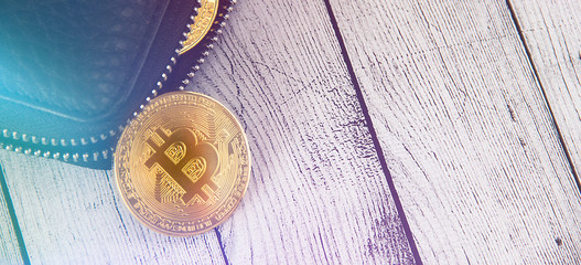 Bitcoins on wallet.Bitcoin falls out of the purse.Business concept