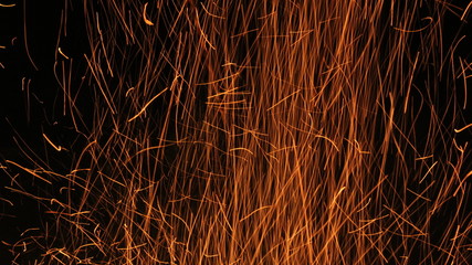 long curved lines of sparkles on black background