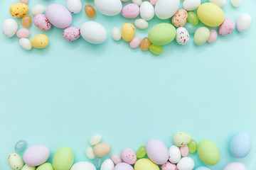 Fototapeta na wymiar Happy Easter concept. Easter candy chocolate eggs and jellybean sweets isolated on trendy pastel blue background. Simple minimalism flat lay top view copy space