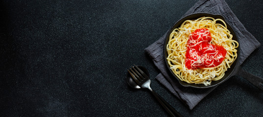 Spaghetti pasta with heart shaped tomato sauce, served in a pan. Dinner for Valentine's Day. Food...