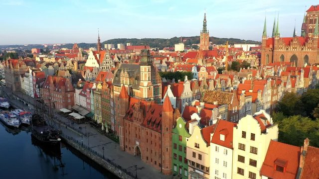 Gdansk, Poland. Aerial 4K reveal video of old city, Motlawa river and famous monuments: Gothic St Mary church, city hall tower,