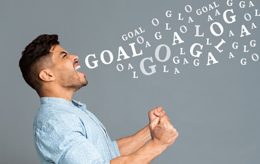 Euphoric guy, football fan emotionally screaming over gray background