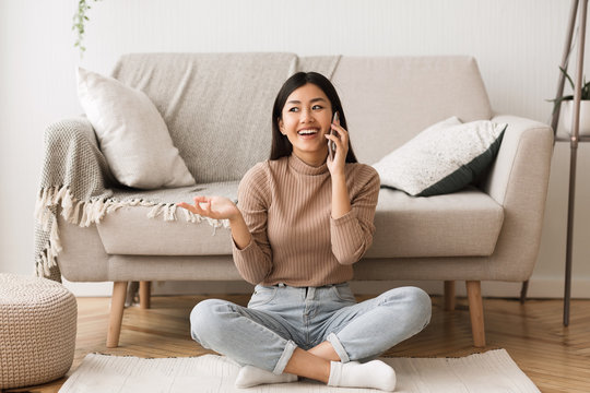 Overjoyed Asian Girl Talking On Cellphone With Friend