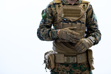 closeup of soldier hands putting protective battle gloves