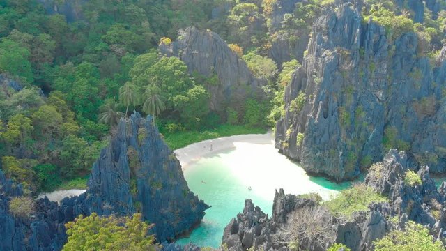 Aerial drone view of Hidden beach on Matinloc Island in El Nido, Palawan, Philippines - Tour C route - Paradise lagoon in tropical scenery