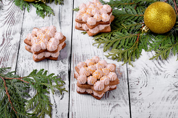 Honey star cake with cream topped with golden sugar on the white wooden table. Festive dessert