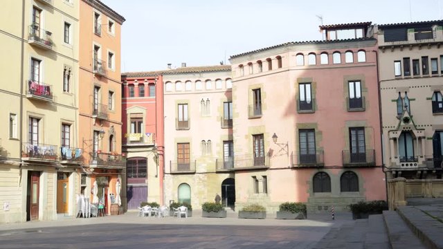 View of the northern part of the Cathedral square where some people walk. Vic, Catalonia, Spain
