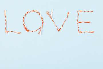 Valentines day composition with Love word on blue background.