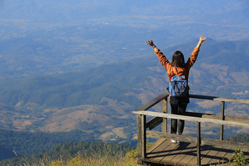 girl raise the arm on chiang rai doi inthanon peak in thailand, the highest mountain in thailand