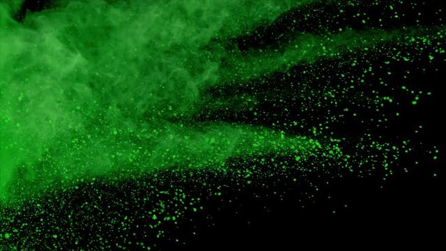 Realistic green powder explosion on black background. Slow motion movement with acceleration from left of screen.