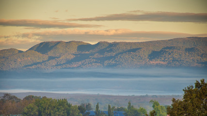 Scenic View Of Mountains Against Sky During Sunrise