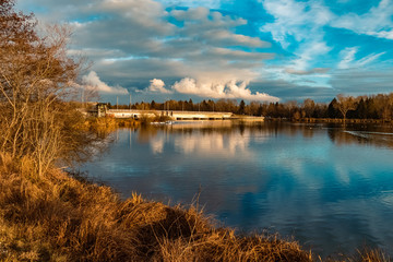 Beautiful autumn or indian summer view with reflections and dramatic clouds near Plattling, Isar, Bavaria, Germany