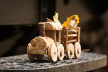 Toy wooden children's steam locomotive rides in the park