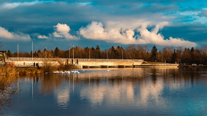Beautiful autumn or indian summer view with reflections and dramatic clouds near Plattling, Isar,...
