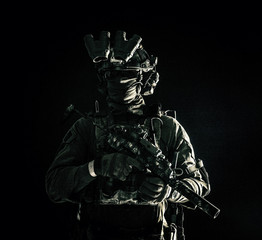 Army special operations forces soldier in mask and combat uniform, helmet equipped night-vision...