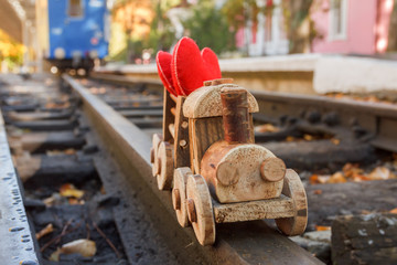 Toy wooden children's steam locomotive rides in the park