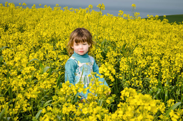 beautiful girl in rapeseed in bloom