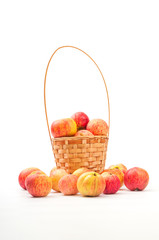 Wicker basket with fresh an apples on white background