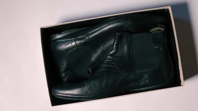 Black men leather shoes are in the box.