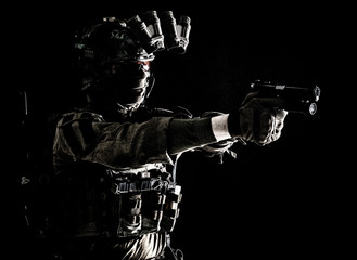 Modern soldier, counter terrorist squad fighter in combat uniform, helmet and tactical radio...