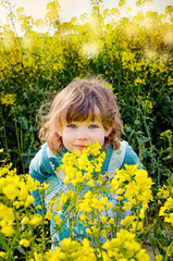 beautiful girl in rapeseed in bloom