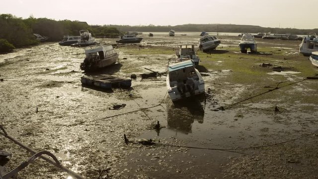 Aerial drone flight over boats at low tide at aground, Bali, Indonesia, 4k