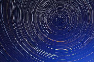 Long exposure starry sky, twisted tracks of stars.