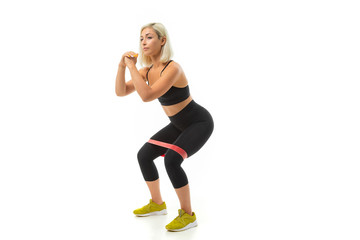 Sport caucasian girl do sports with elastic band expander, portrait isolated on white background